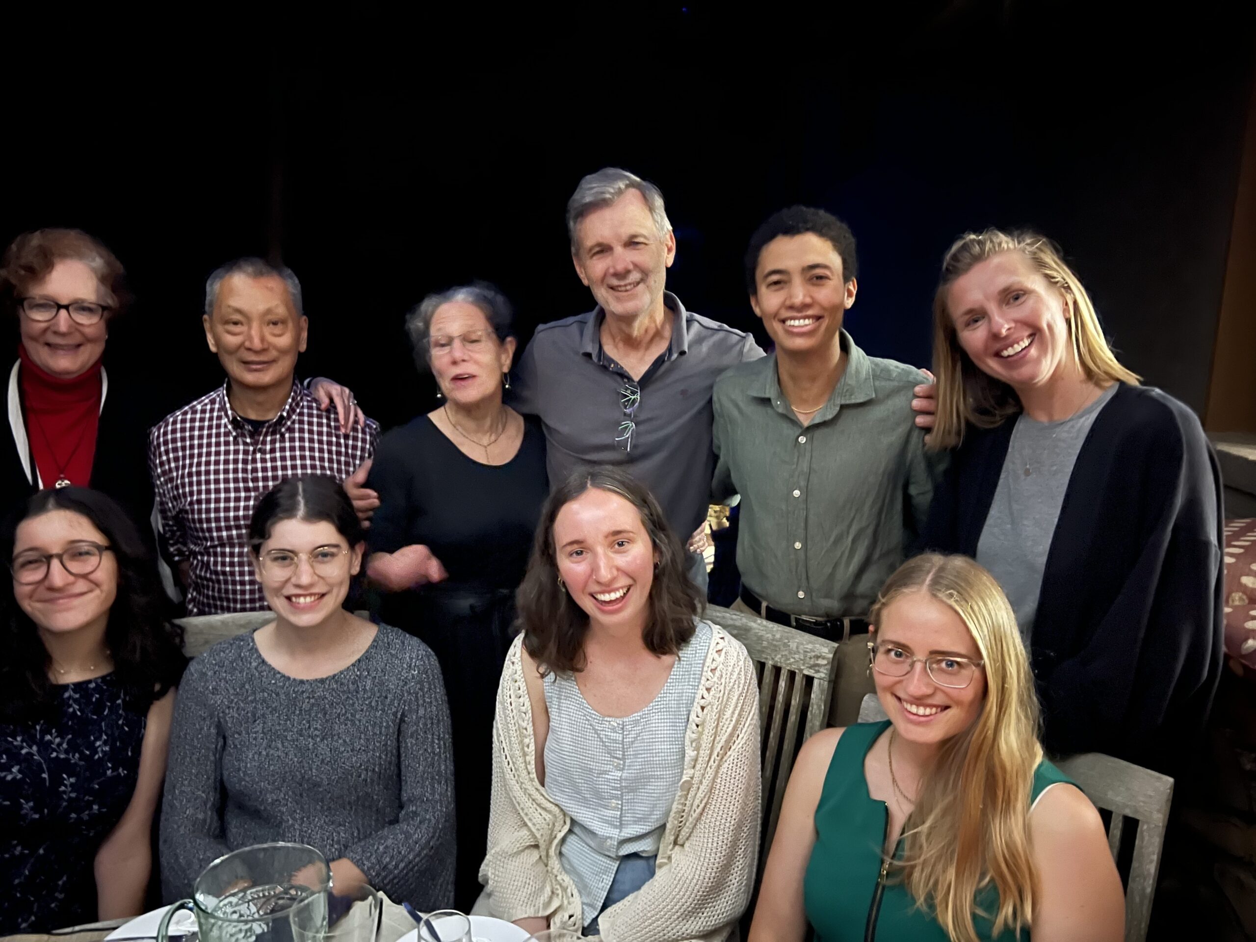 Group of 10 people (Clark lab + Ren's family) smiling at the camera celebrating Ren's successful defense.